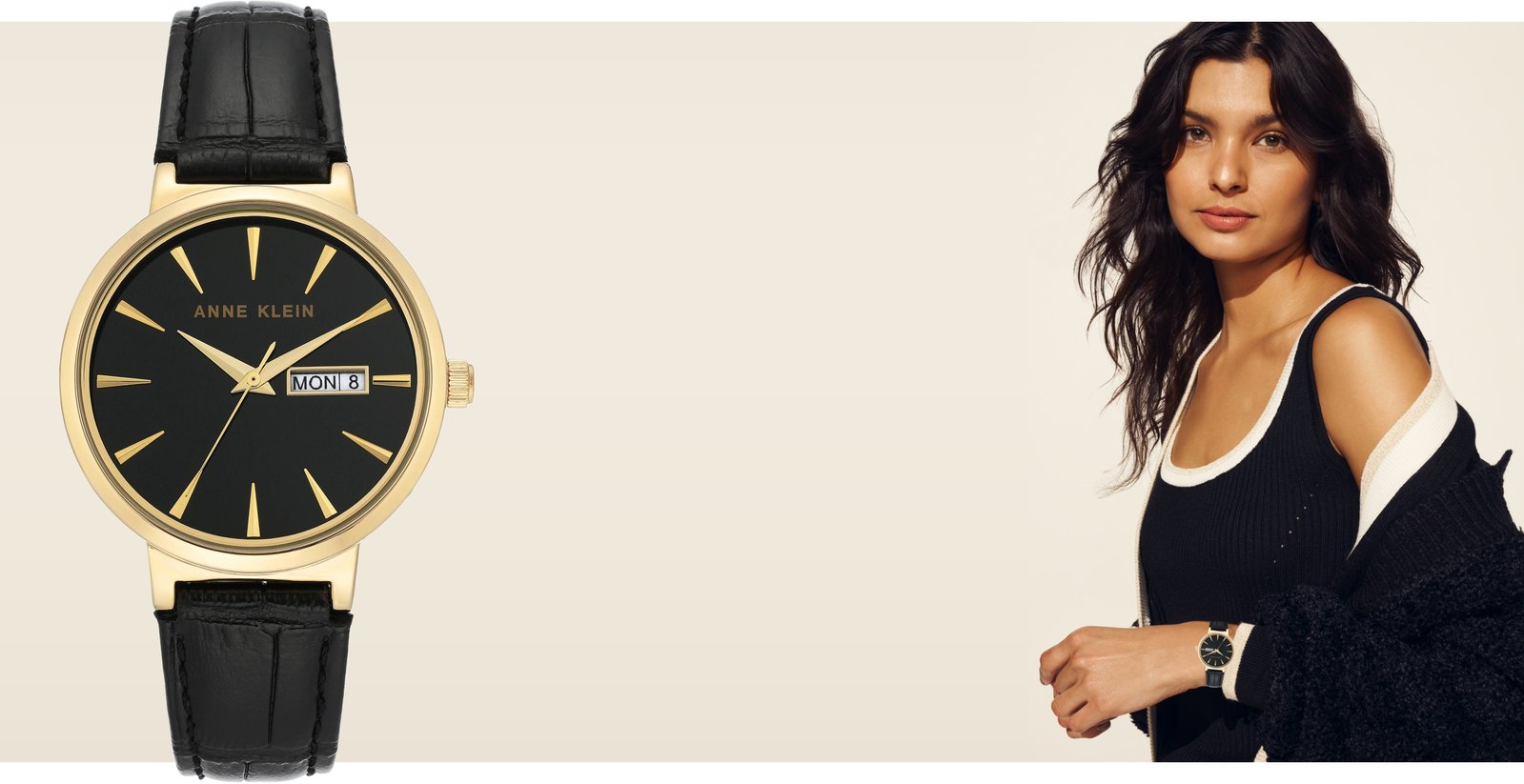 Large image of a black Anne Klein watch with model wearing the same watch and a black sweater set next to it