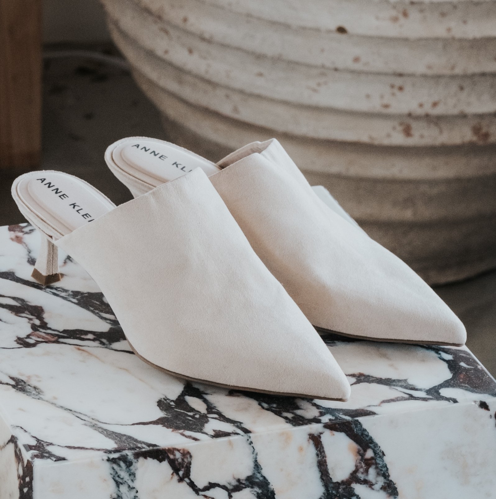 Anne Klein Impress Oat Mules on marble stand
