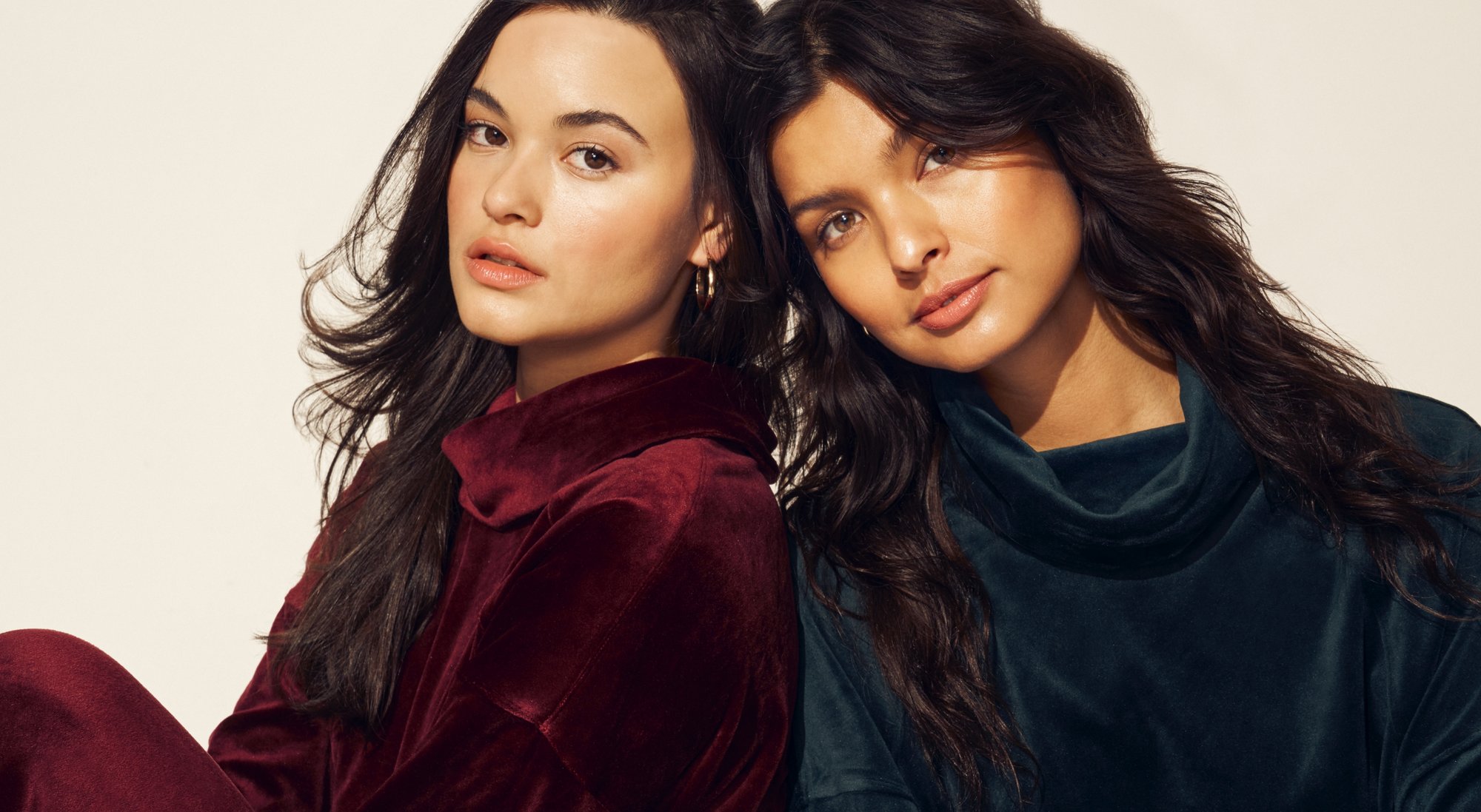 2 Anne Klein models leaning on each other wearing velour matching sets