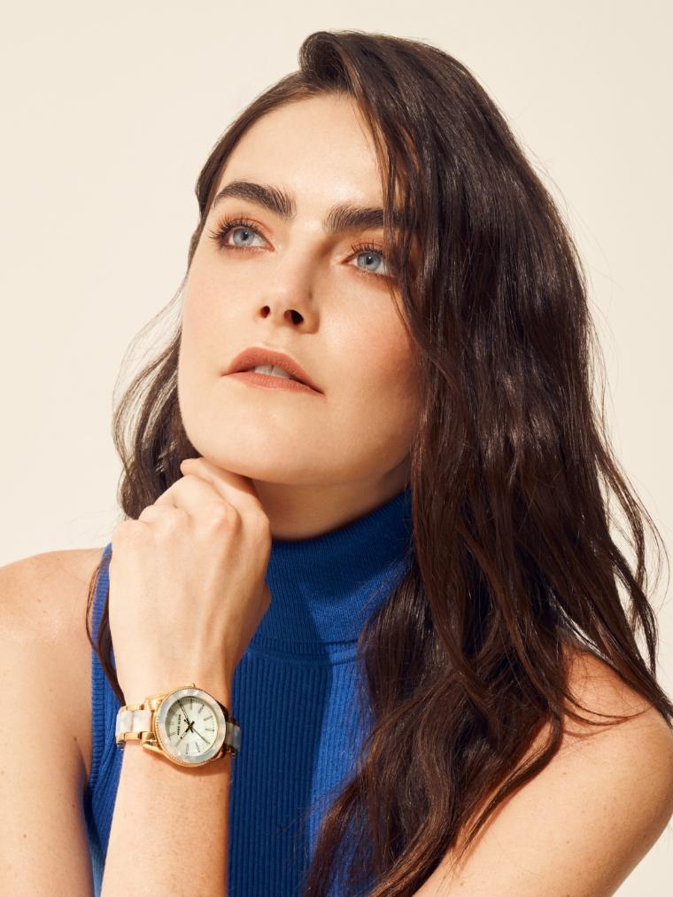 Anne Klein model in blue turtleneck with blue watch on